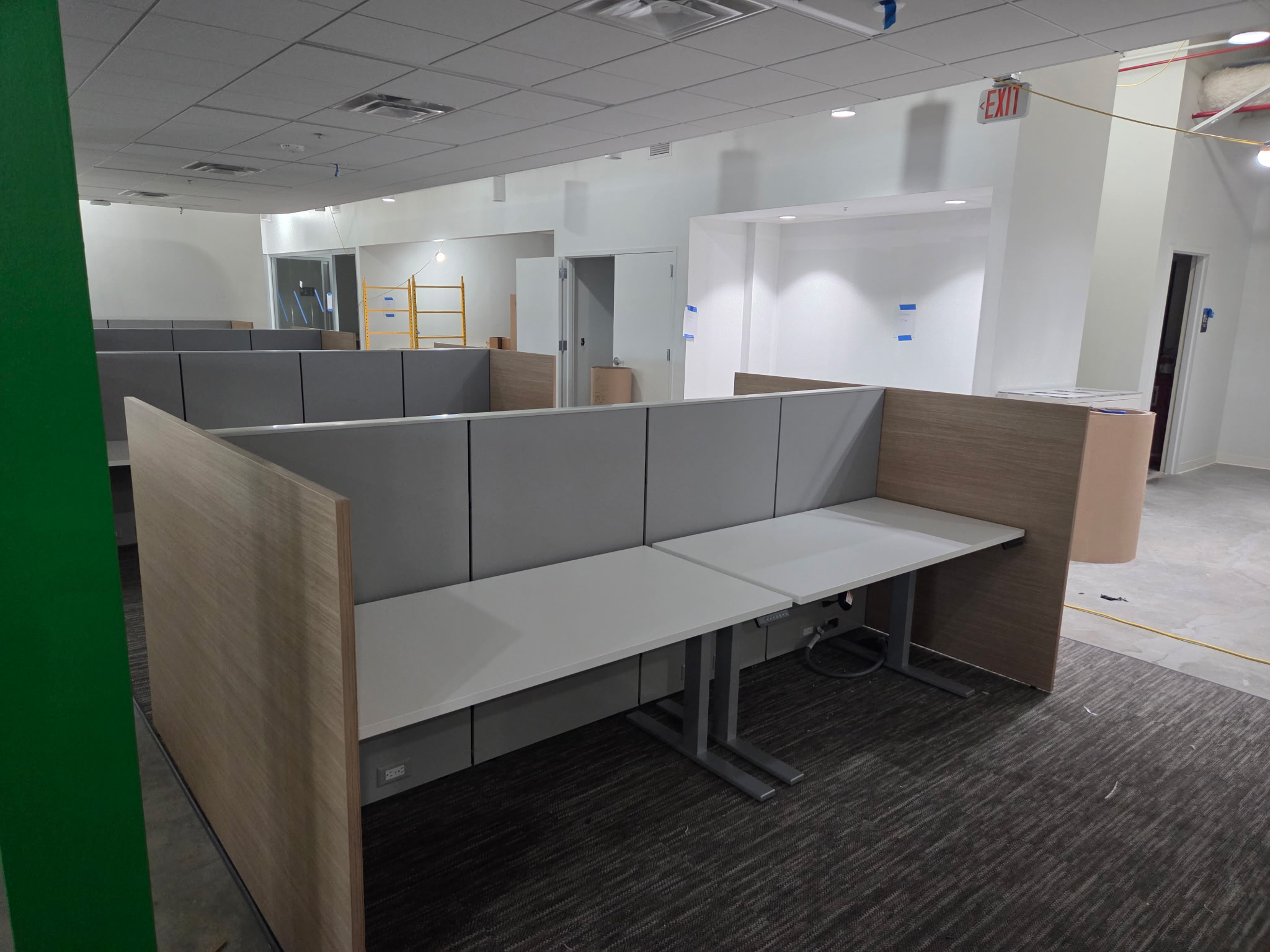 Panel workstations with gray desktops and wood end panels