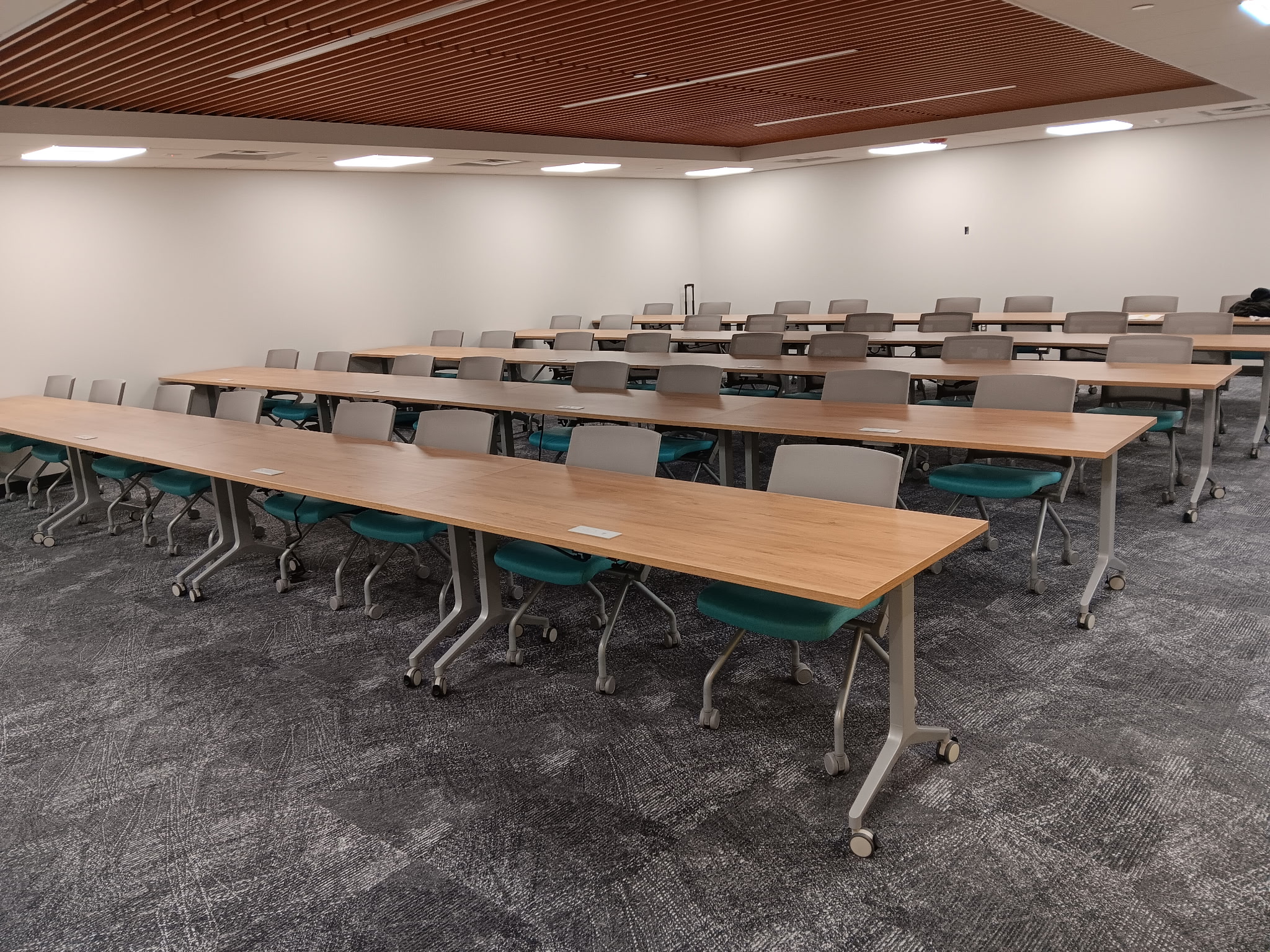 Training tables with chairs arranged in classroom rows